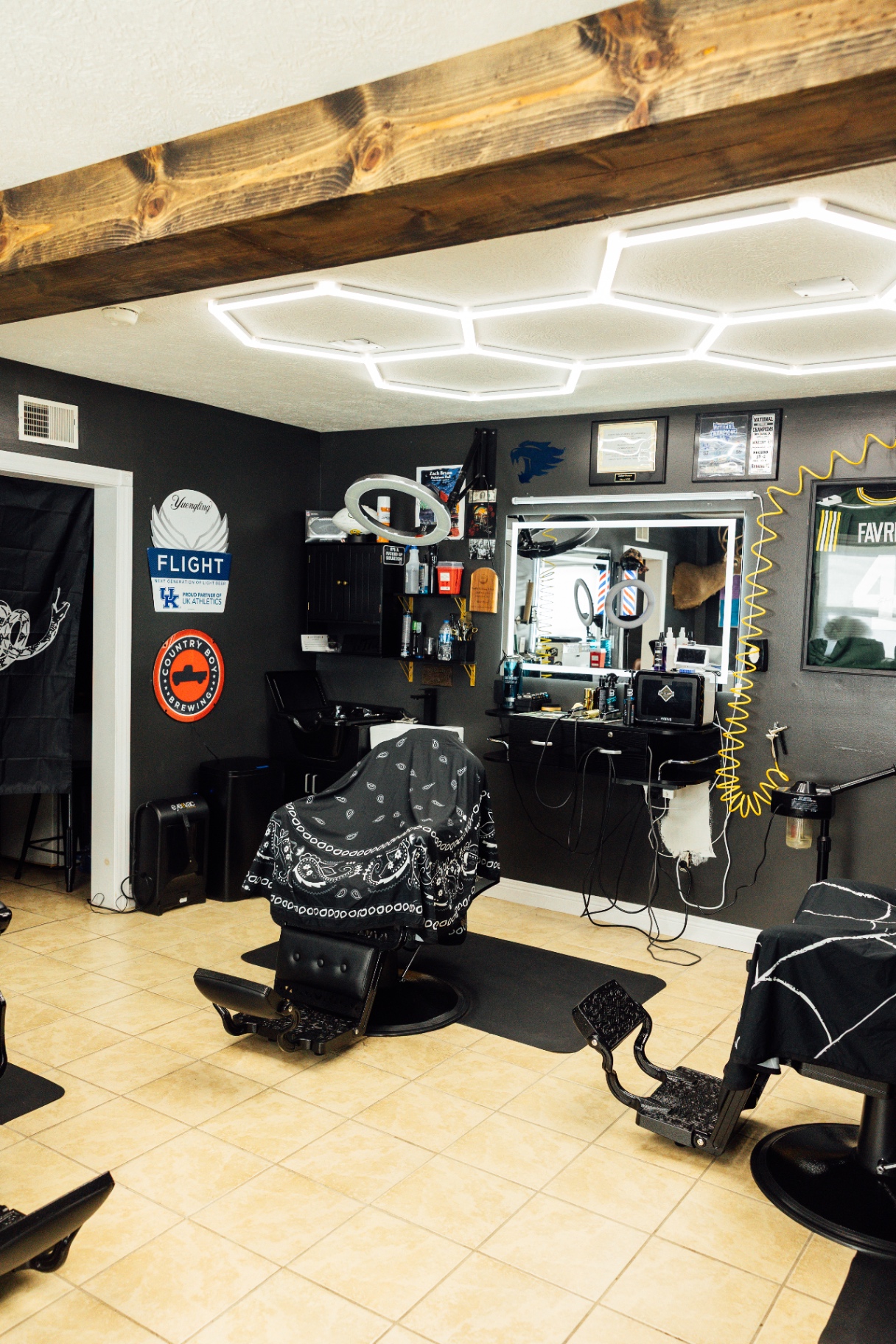 Inside the Ace of Fades barbershop with hexagon lighting and chairs